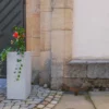 Bunt bepflanzter Trog aus Beton steht in öffentlichem Bereich
